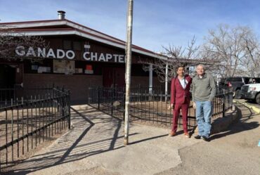 Two people stand outside of Ganado Chapter House of the Navajo Nation in Ganado, AZ.